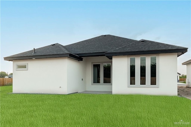 3216 E Alexa St, Edinburg, TX 78542 - rear view of house featuring a shingled roof, a lawn, and stucco siding