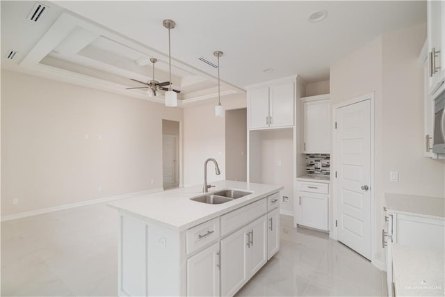 3216 E Alexa St, Edinburg, TX 78542 - kitchen with a sink, a ceiling fan, white cabinets, decorative light fixtures, and decorative backsplash