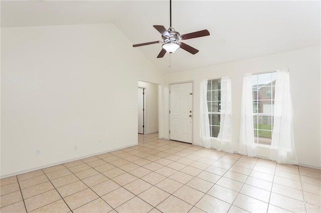 empty room with light tile patterned floors, high vaulted ceiling, and ceiling fan