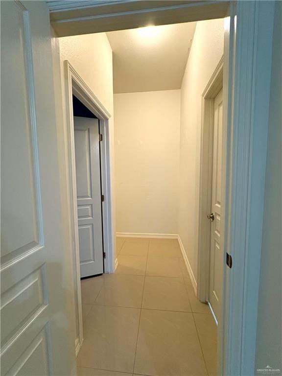 corridor featuring light tile patterned floors