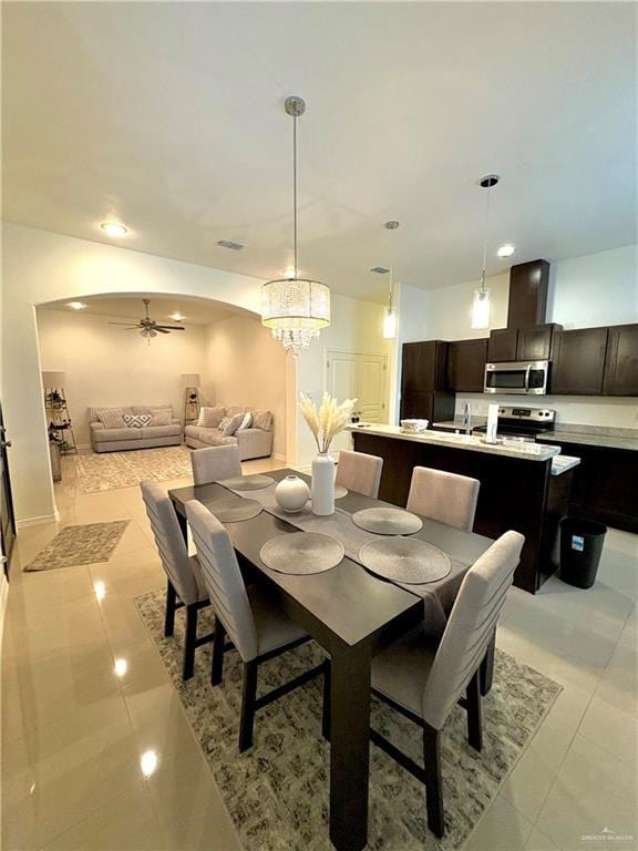 tiled dining area featuring sink and ceiling fan