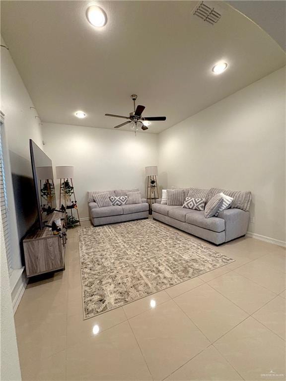 living room with light tile patterned flooring and ceiling fan