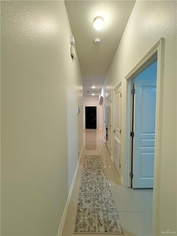 hallway featuring light tile patterned flooring