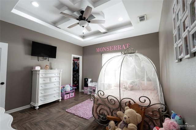 bedroom featuring ceiling fan, a closet, coffered ceiling, and dark parquet floors