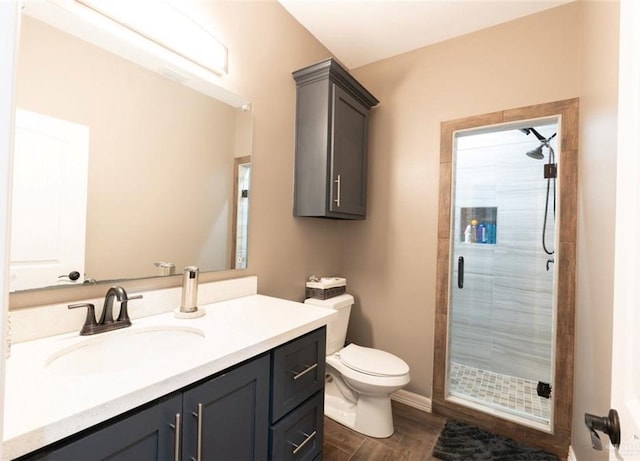 bathroom featuring walk in shower, vanity, toilet, and hardwood / wood-style floors