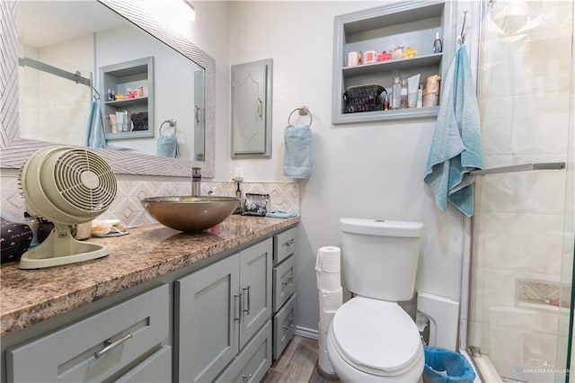 bathroom featuring hardwood / wood-style flooring, vanity, toilet, and walk in shower