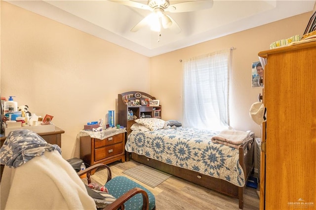 bedroom with ceiling fan and light hardwood / wood-style floors