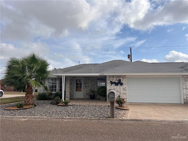 151 Tulip St, Mission, TX 78504 - single story home featuring a garage, driveway, brick siding, and roof with shingles