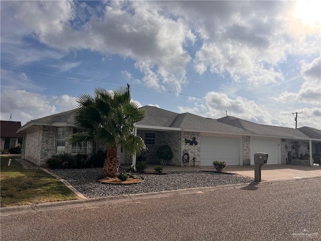 151 Tulip St, Mission, TX 78504 - ranch-style house with an attached garage, driveway, and brick siding