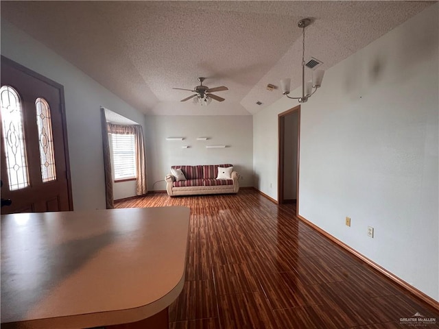 151 Tulip St, Mission, TX 78504 - unfurnished living room with a textured ceiling, a ceiling fan, and vaulted ceiling