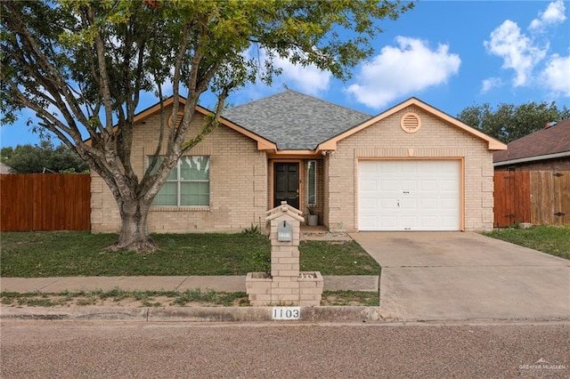 1103 Sun Valley St, San Juan, TX 78589 - single story home with a garage, driveway, brick siding, and a shingled roof
