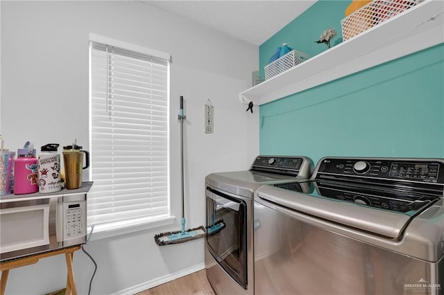 1103 Sun Valley St, San Juan, TX 78589 - washroom featuring washing machine and clothes dryer, baseboards, and light wood-style flooring