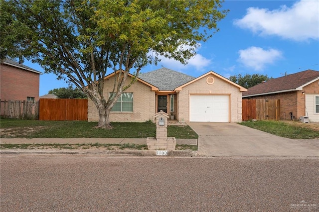 1103 Sun Valley St, San Juan, TX 78589 - ranch-style house featuring a garage, driveway, and brick siding