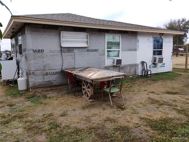 rear view of property featuring cooling unit