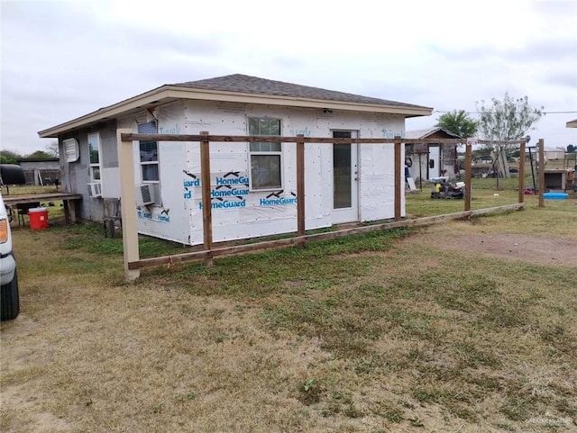 exterior space with cooling unit and a yard