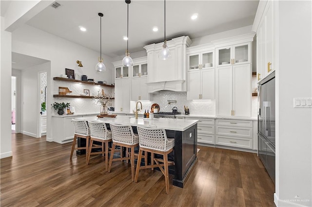 1801 E 28th St, Mission, TX 78574 - kitchen with backsplash, white cabinetry, a breakfast bar, dark wood finished floors, and recessed lighting