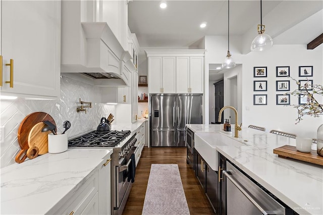 1801 E 28th St, Mission, TX 78574 - kitchen featuring stainless steel appliances, custom range hood, a sink, white cabinets, and pendant lighting