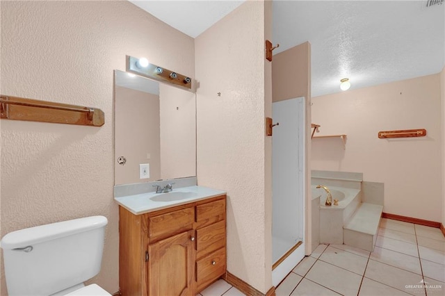 4113 Sonora Ave, Mcallen, TX 78503 - bathroom featuring vanity, a garden tub, a textured wall, toilet, and tile patterned floors