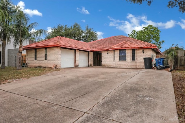 4113 Sonora Ave, Mcallen, TX 78503 - ranch-style home featuring a garage, fence, brick siding, a tiled roof, and concrete driveway