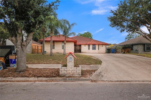 4113 Sonora Ave, Mcallen, TX 78503 - ranch-style house with concrete driveway, fence, a tile roof, and stucco siding