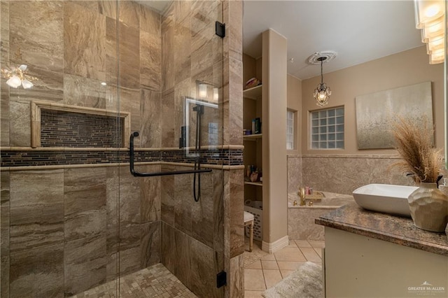 bathroom with vanity, a shower with shower door, tile patterned flooring, and built in features