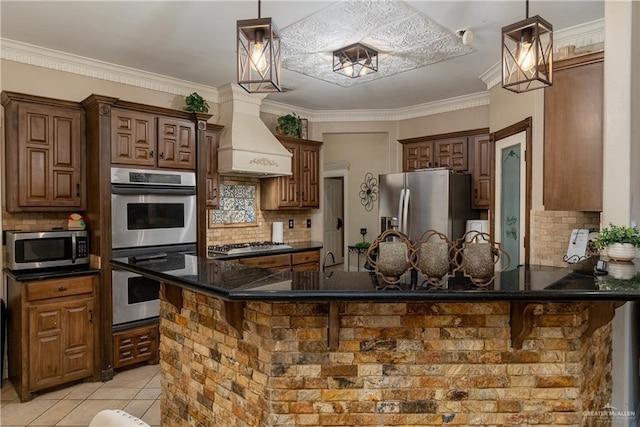 kitchen featuring appliances with stainless steel finishes, a kitchen breakfast bar, custom range hood, and backsplash