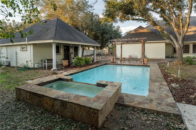 view of pool with an in ground hot tub and a pergola