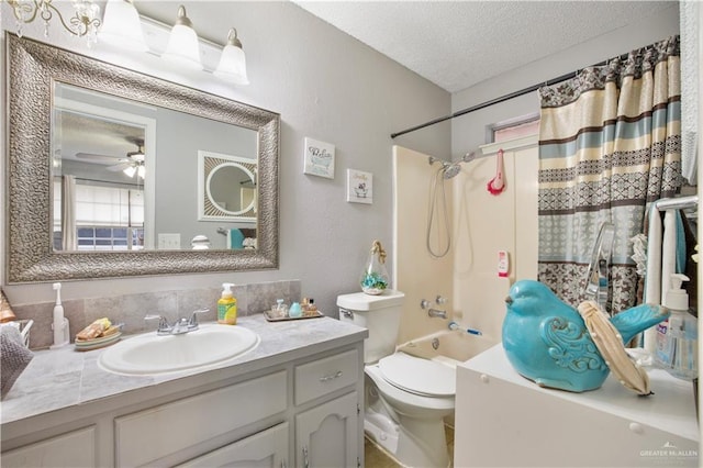 bathroom with shower / bath combination, toilet, ceiling fan, a textured ceiling, and vanity