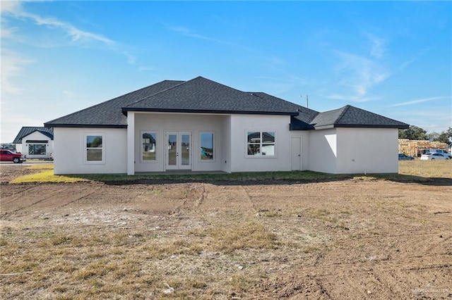 back of house featuring french doors and a yard