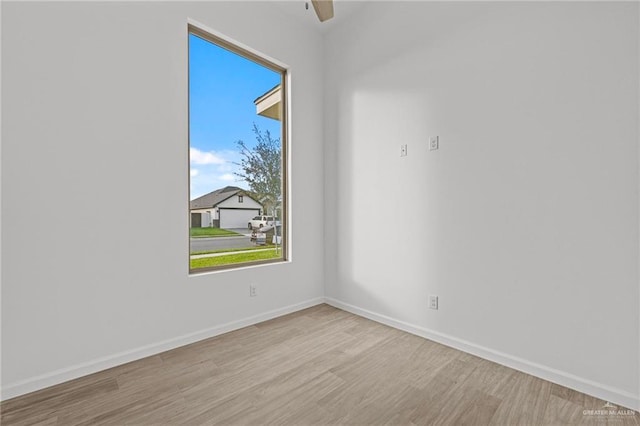 empty room featuring ceiling fan and light hardwood / wood-style floors