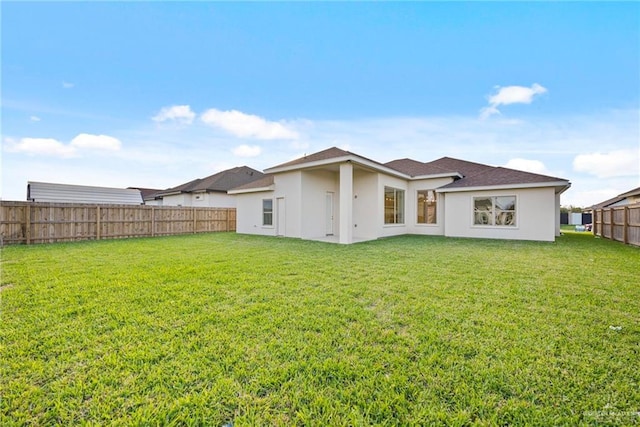 rear view of house with a lawn