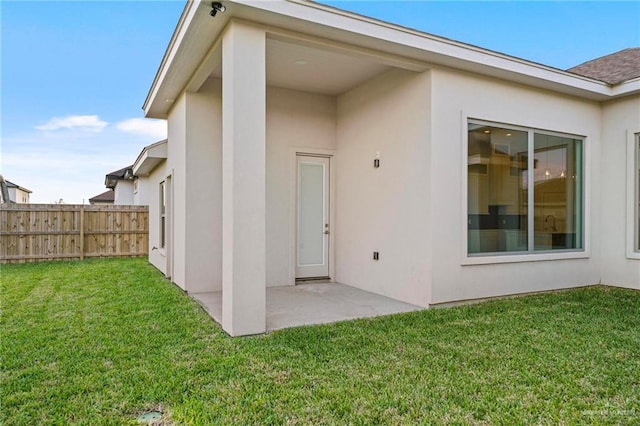 back of house featuring a yard and a patio