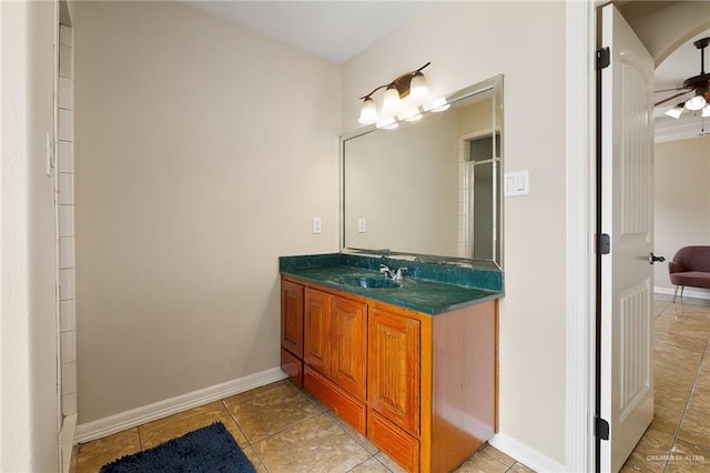 bathroom with tile patterned flooring, vanity, and baseboards