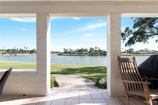 view of patio / terrace with area for grilling and a water view