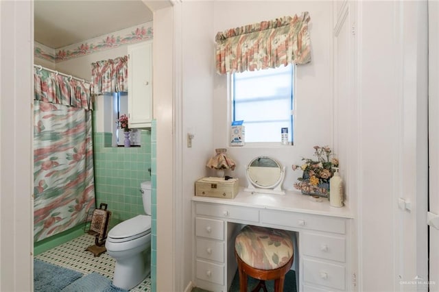 bathroom featuring a shower with shower curtain, vanity, and toilet