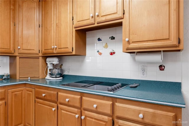 kitchen featuring black electric cooktop and tasteful backsplash