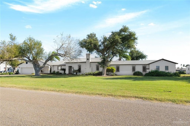 ranch-style home with a front lawn