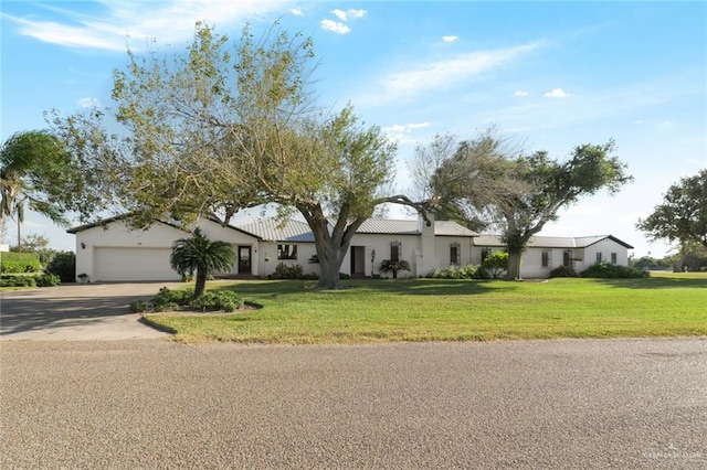 view of front facade with a garage and a front lawn