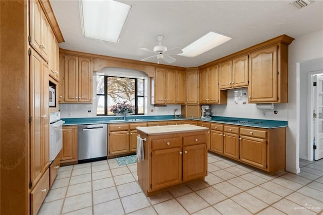 kitchen featuring white appliances, ceiling fan, sink, light tile patterned floors, and a center island