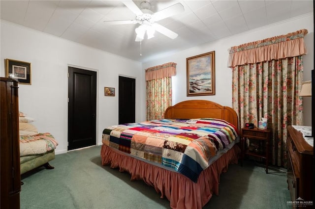 bedroom featuring dark colored carpet, ceiling fan, and ornamental molding