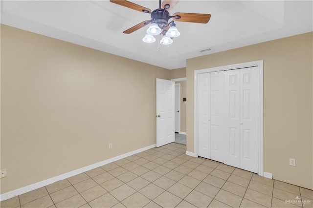 unfurnished bedroom featuring light tile patterned floors, a closet, and ceiling fan