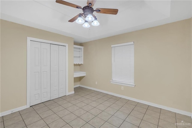 unfurnished bedroom featuring a closet, ceiling fan, and light tile patterned flooring