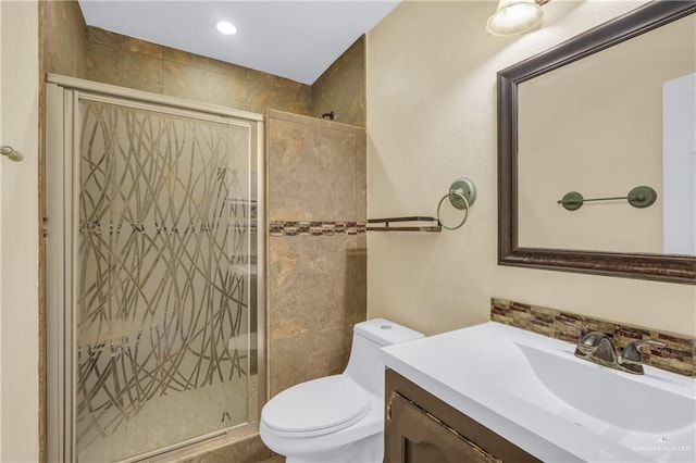 bathroom with vanity, toilet, and an enclosed shower