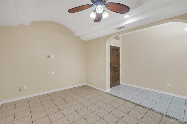 spare room with ceiling fan and light tile patterned floors