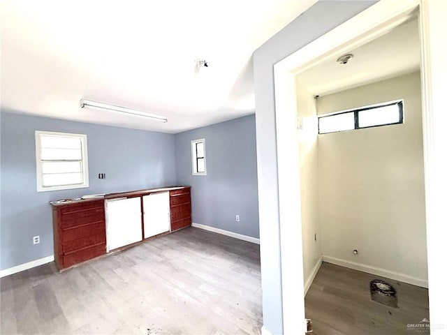 laundry room featuring wood finished floors and baseboards