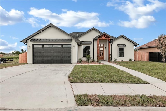 view of front of property featuring a front lawn and a garage