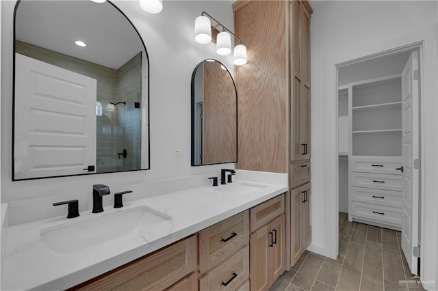 bathroom with a shower, vanity, and hardwood / wood-style flooring