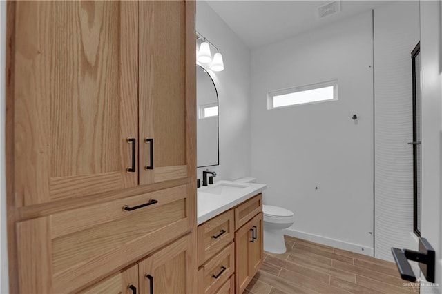 bathroom with hardwood / wood-style flooring, vanity, and toilet