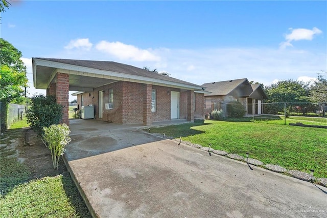 view of property exterior with a carport and a yard