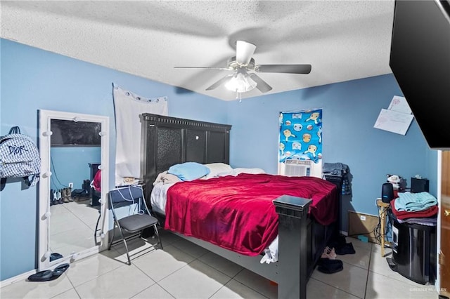 tiled bedroom with a textured ceiling and ceiling fan